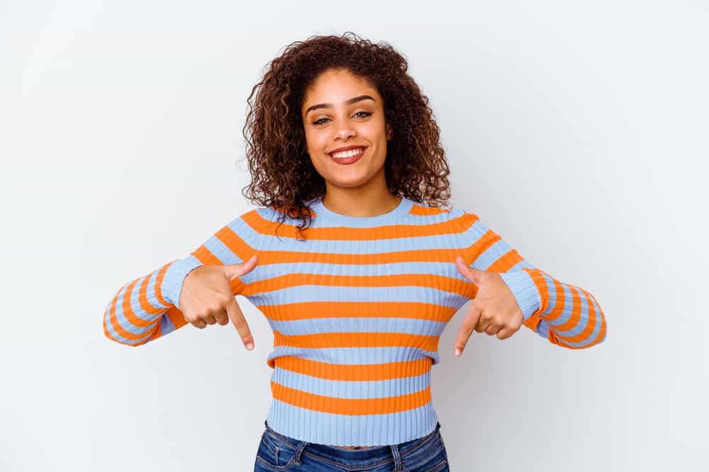 A black female with an odd style that looks like wet hair with darker hair underneath and red hair on top.