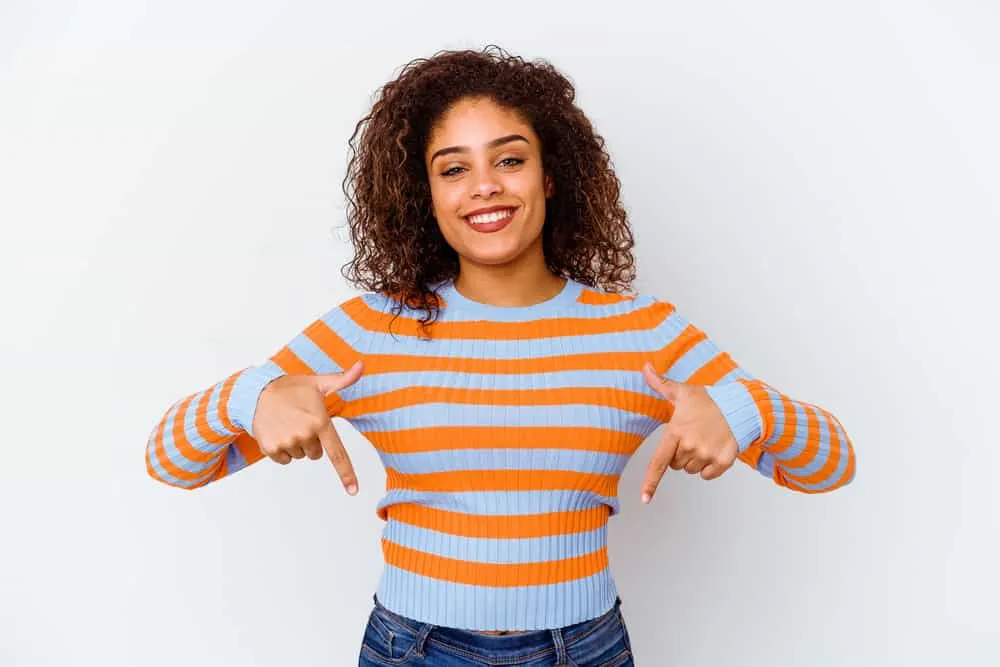 What Is a Hair Lightener? How Does Hair Lightener Work? 7 A black female with an odd style that looks like wet hair with darker hair underneath and red hair on top.