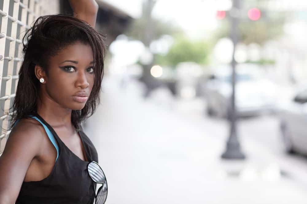 A fashionable lady starting a healthy hair journey on her type 4 hair texture is using a relaxer-friendly hair routine.