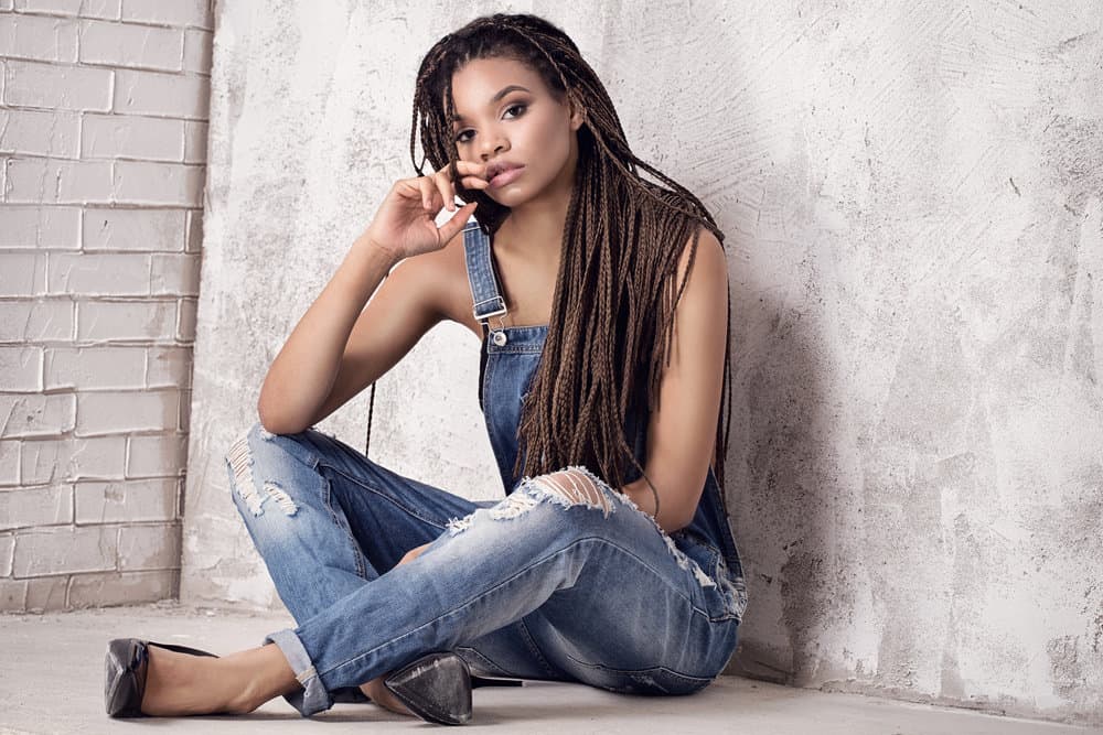 A fashionable young lady that keeps her hair moisturized with coconut oil and a leave-in conditioner.