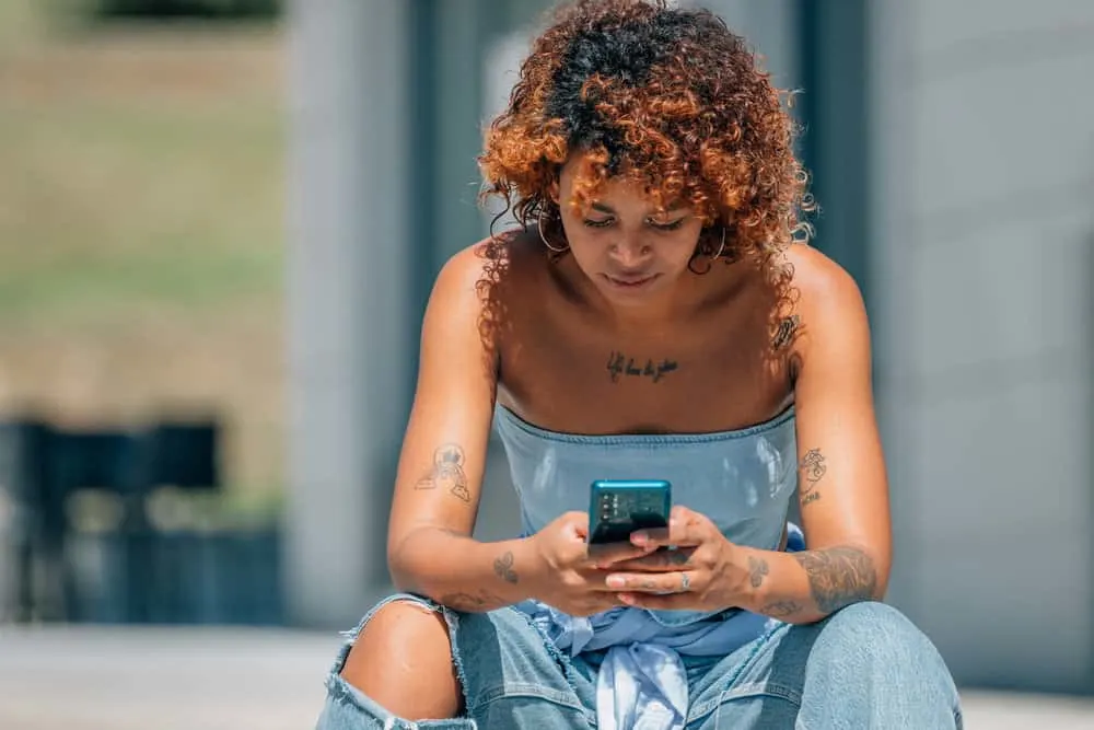 Can You Dye Your Hair Right After Bleaching It? What Happens? 4 An urban Latin African American female researching whether you can dye bleached hair with store-bought box dye.