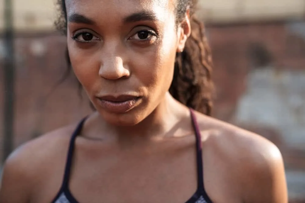 Why Does My Hair Itch When I Sweat, Get Hot, or Workout? 5 A black female that's working with a Board Certified Dermatologist because of her scalp's itching sensation.
