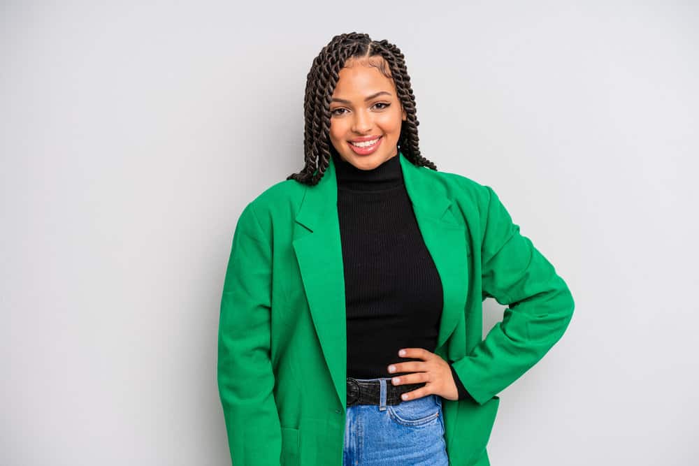 A pretty black girl wearing loose two-strand twists with hair extensions to create more hair length for her 3B curls.