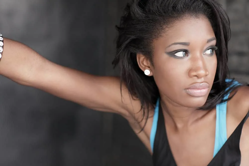 How To Moisturize Relaxed Hair Without Weighing It Down 2 A black girl with a medium chocolate skin tone has dry hair that needs intense hydration due to protein overload.