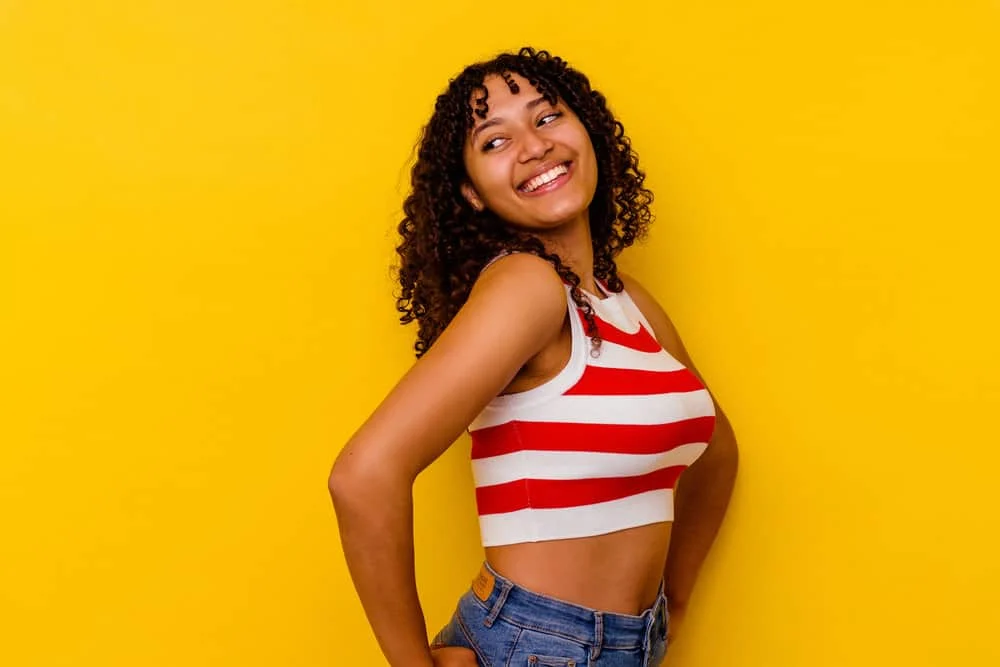 How to Stop Wave Nouveau Breakage: DIY Step-by-Step Guide 2 African American female with a healthy hair care routine that compliments her Wave Nouveau style silky hair strands.