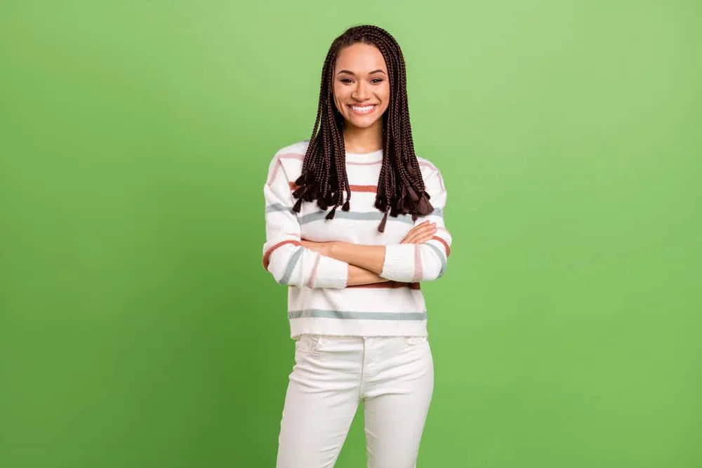 How To Soften Synthetic Braids: Step-by-Step for Beginners 6 A pretty African American female wearing a time-consuming braided hairstyle after soaking her hair in cold water.