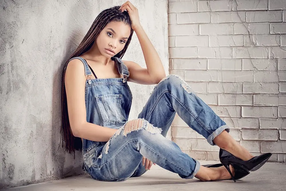 How Long Do Micro Braids Take, Last, Cost, and Other FAQs 1 A beautiful African American female with frizzy hair wearing micro box braids using synthetic hair extensions.