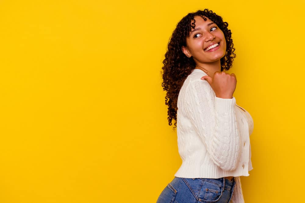 African American female with a 3B curly texture and S-shaped curls is wearing her hair strands in their natural pattern.