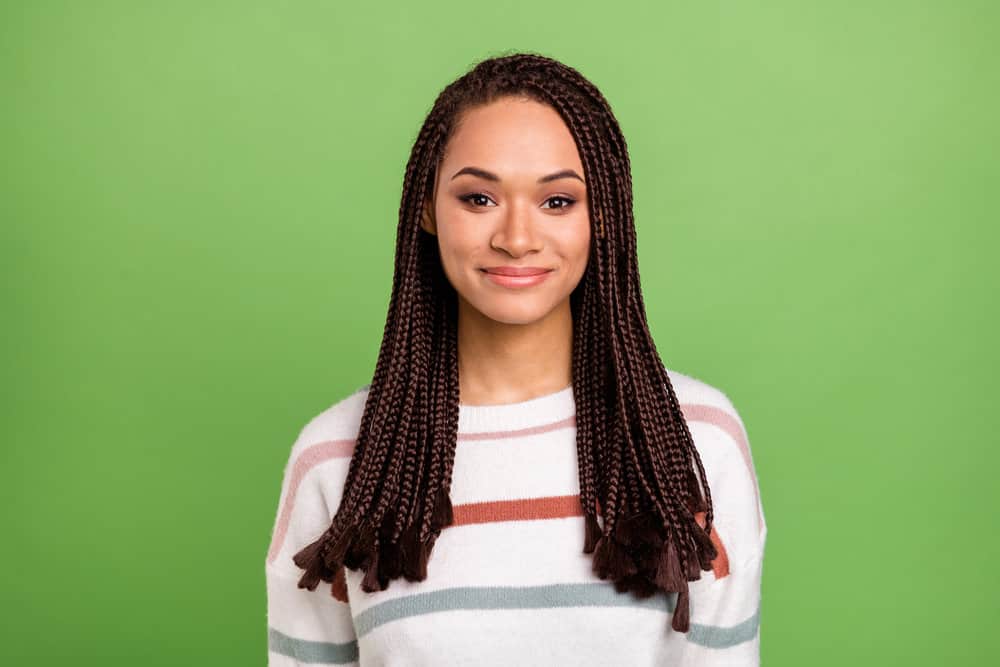 A young, light-skinned lady with beautiful braids was cleaned with dry shampoo to remove dirt and product buildup.