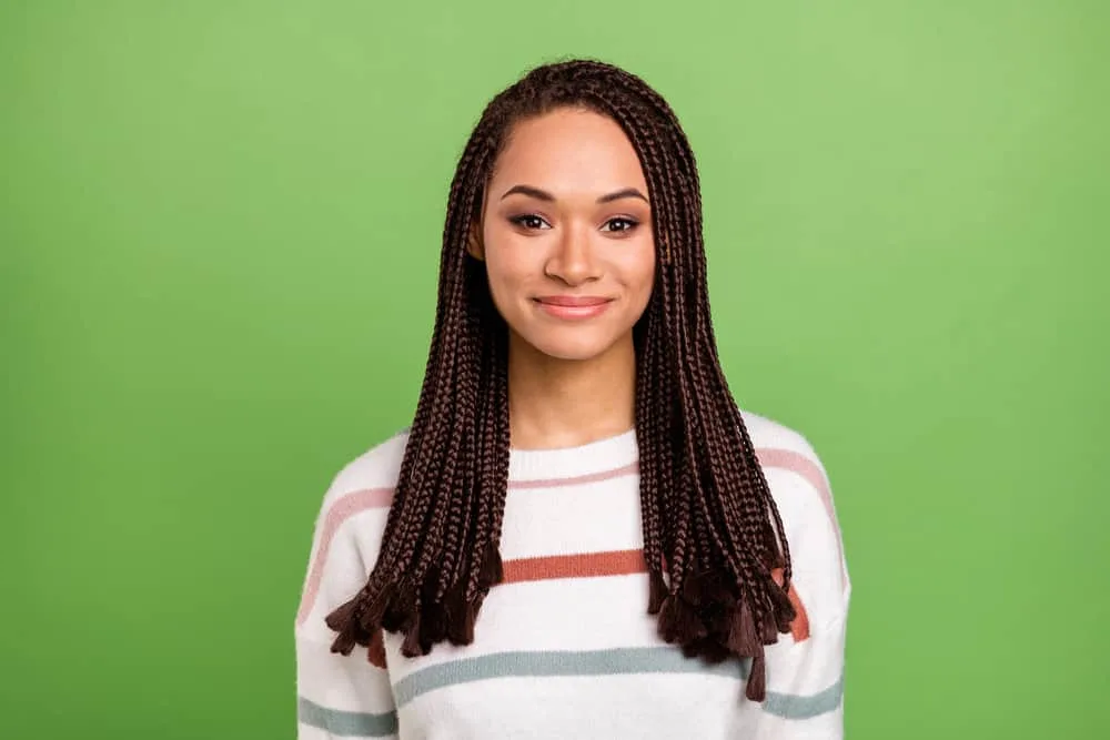 How To Soften Synthetic Braids: Step-by-Step for Beginners 5 A young, light-skinned lady with beautiful braids was cleaned with dry shampoo to remove dirt and product buildup.