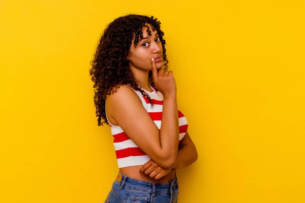 A young mixed-race female with curly natural hair used a wave nouveau kit to encourage hair growth.