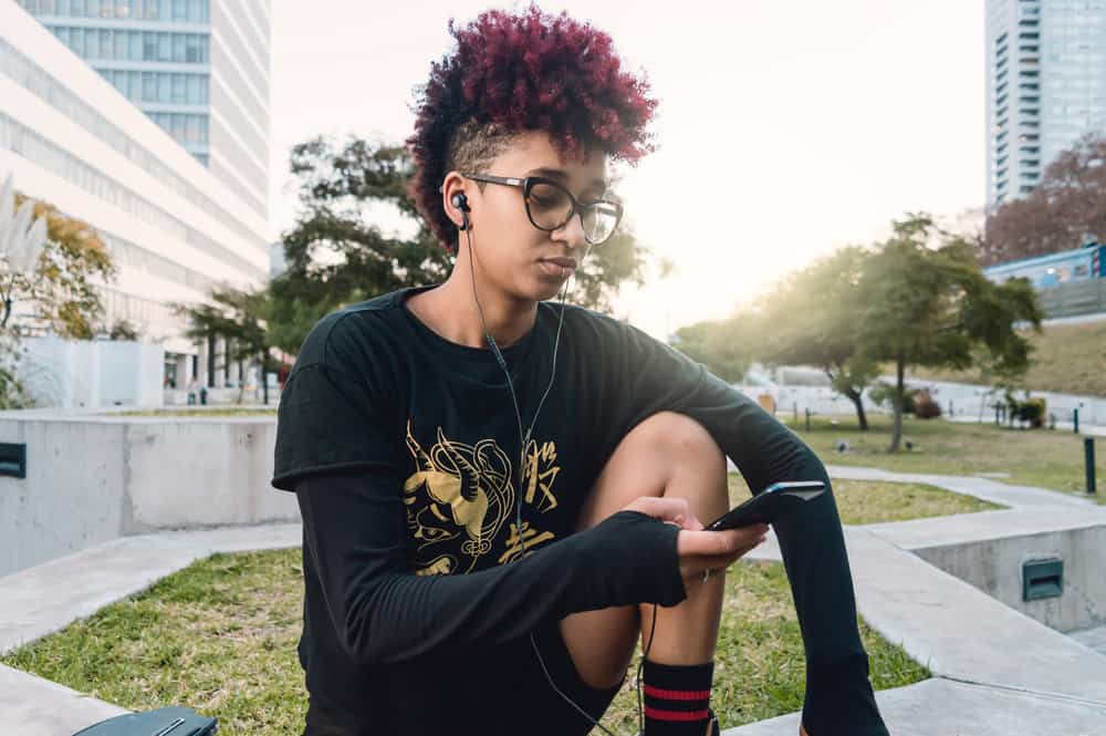 A lady with sensitive skin got her hair bleached at a salon and has a dark red hair color using commercial hair dyes.