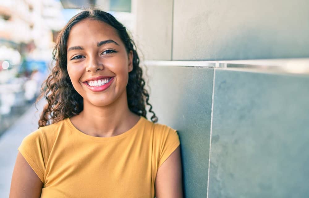 A black lady that understands the importance of edge care avoids heat tools and uses scalp massage techniques.