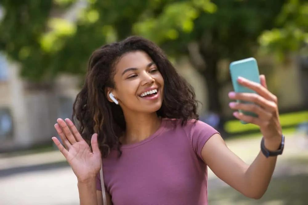 Flash Drying Hair: Is It Bad, Causes, How to Fix It, and More 4 African American female with dark brown hair stands styled with a leave-in conditioner to keep her hair hydrated.