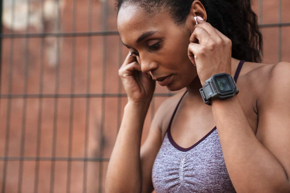 A young black female in sportswear has been struggling with the human itch mite causing consistent scalp itches.