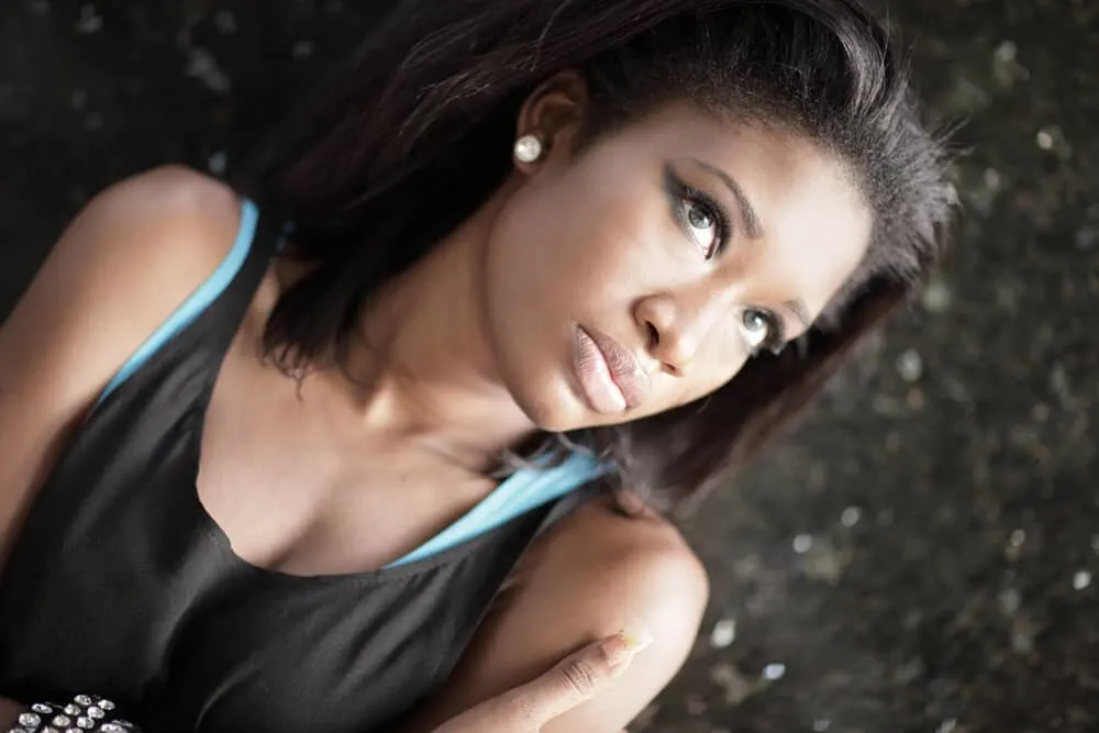 How To Moisturize Relaxed Hair Without Weighing It Down 5 An African lady with curly hair cuticles was damaged from using too much direct heat on her natural curls.