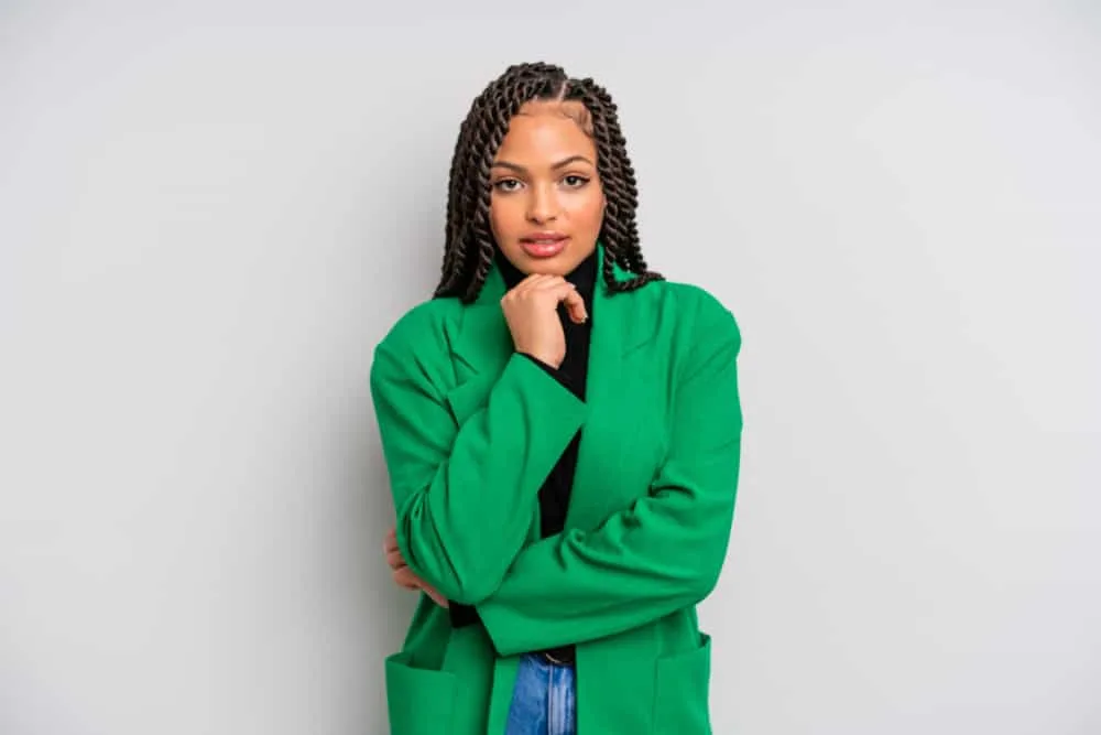Does Twisting Your Hair Make It Grow Faster and Longer? 6 A happy young black woman wearing relatively thin micro twists moisturized with flaxseed gel and good fats.