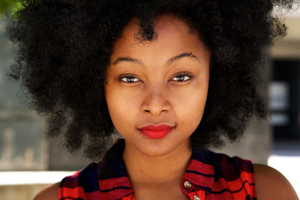 A beautiful African female with afro-textured hair, tightly coiled defined curls, and a lovely wash-n-go hairstyle.