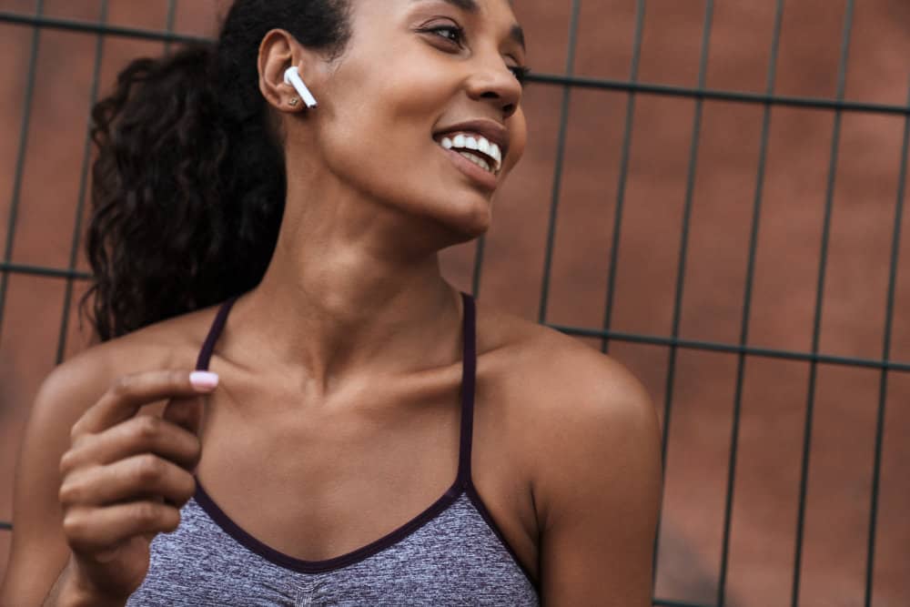 An African American female listening to a podcast about skin cancer and its impacts on your immune system.