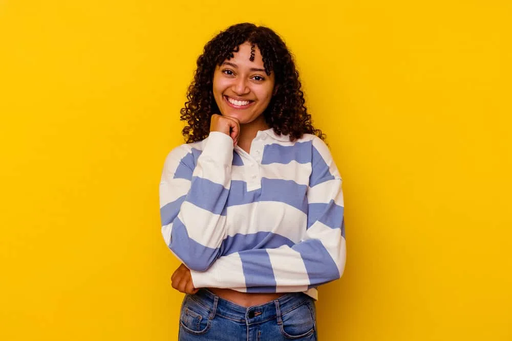 Does Your Scalp Itch When Your Hair Is Growing? Solutions? 3 A cute African American lady with curly baby hair strands showing hair regrowth while her scalp itches.