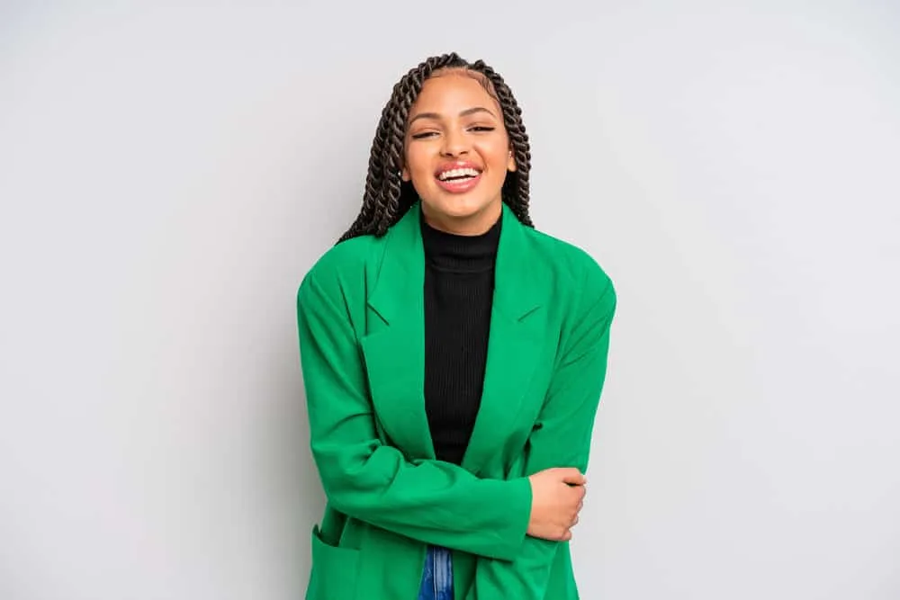 Does Twisting Your Hair Make It Grow Faster and Longer? 2 A friendly young black woman with healthy hair wearing twists on her 3B long hair strands styled with coconut oil.