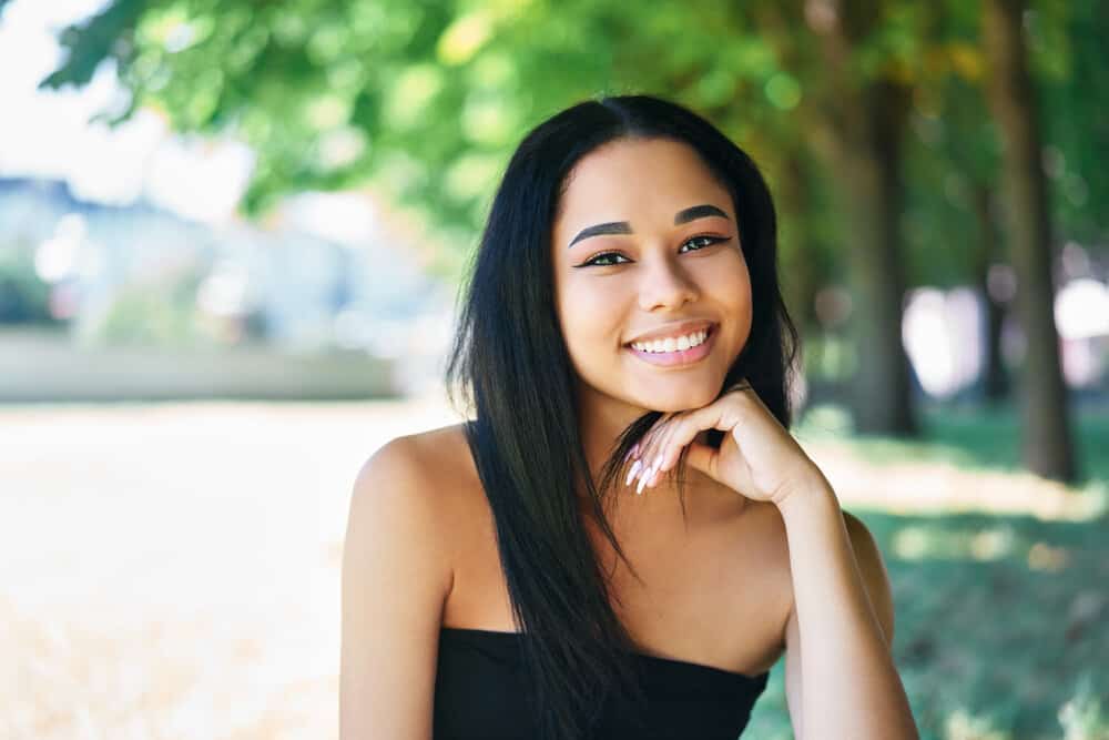 A cute black female with finer hair has straightened strands from daily low-heat exposure with an Ionic dryer.