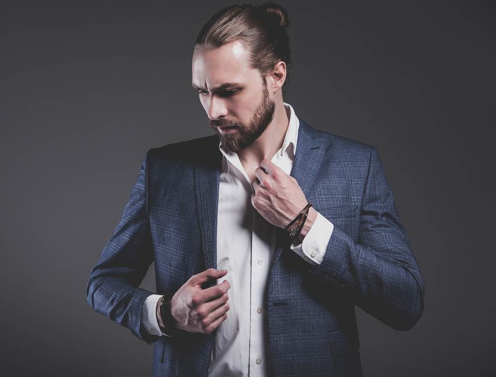 A Caucasian male wearing a semi-bun shape knot hairstyle cleaned with dry shampoo for regular maintenance.