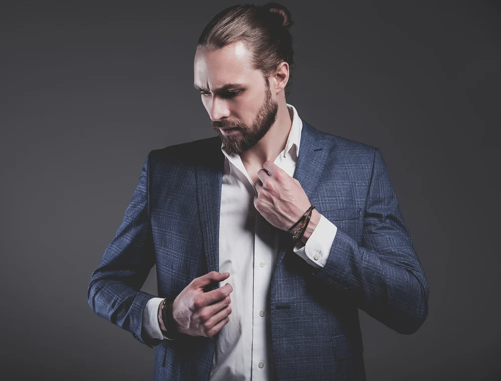How to Do a Man Bun: Step by Step with Short or Long Hair 9 A Caucasian male wearing a semi-bun shape knot hairstyle cleaned with dry shampoo for regular maintenance.