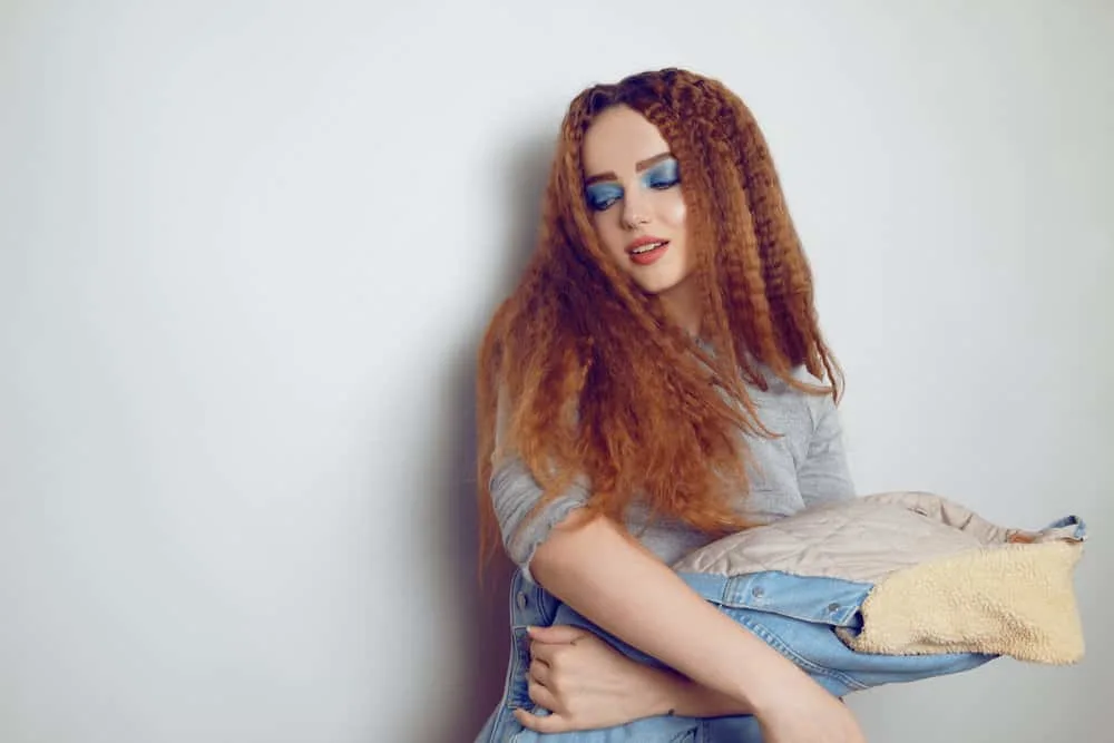 How to Crimp Hair With and Without a Crimper: Step-By-Step 10 A young stylish model with bright blue makeup is wearing an 80s crimped hair style secured with u pins.