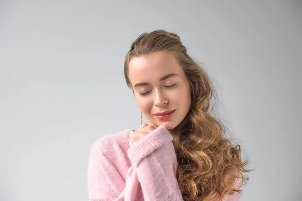How to Use a Curling Iron on Yourself: DIY Step-By-Step 6 A female with healthy hair used heat protection and a GHD curve iron to create softer curls on her long hair.