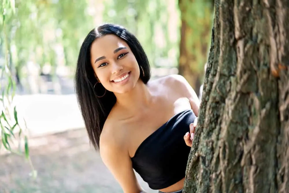 Does Blow Drying Your Hair Damage It? Should You Air Dry? 4 A black lady with subtle hair fiber damage on the ride-side of her head is often caused when you rough dry your hair.