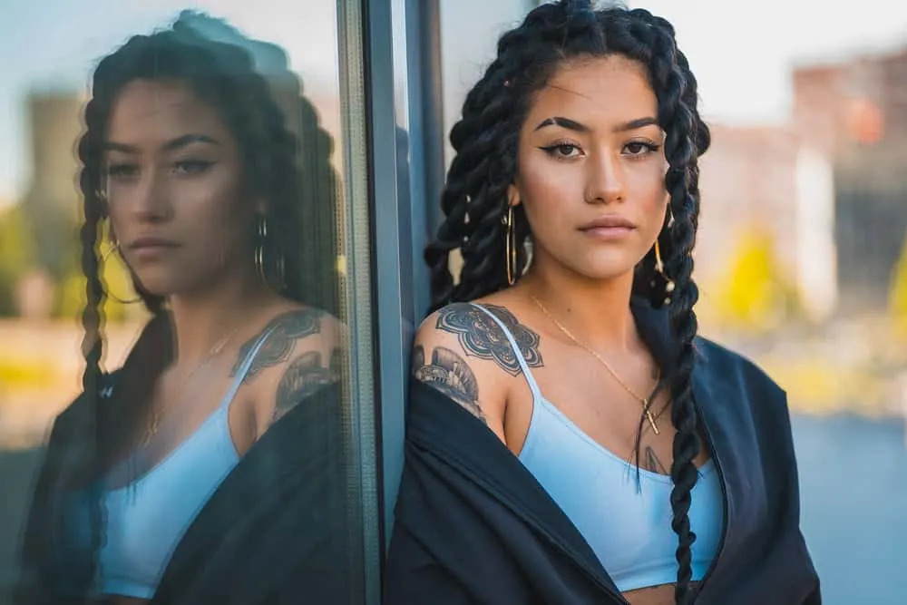Why Your Hair Feels Thin After Braids and Is Thinning Normal 1 A cute young urban female with thin hair after wearing tight braids covering her whole head with extensions.