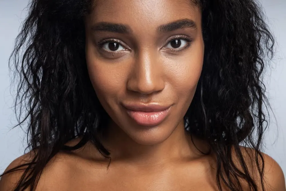 How Often Should You Use a Hair Mask Treatment on Curly Hair 1 A charming female with color-treated hair used a hydrating hair mask to repair split ends on her damaged hair.