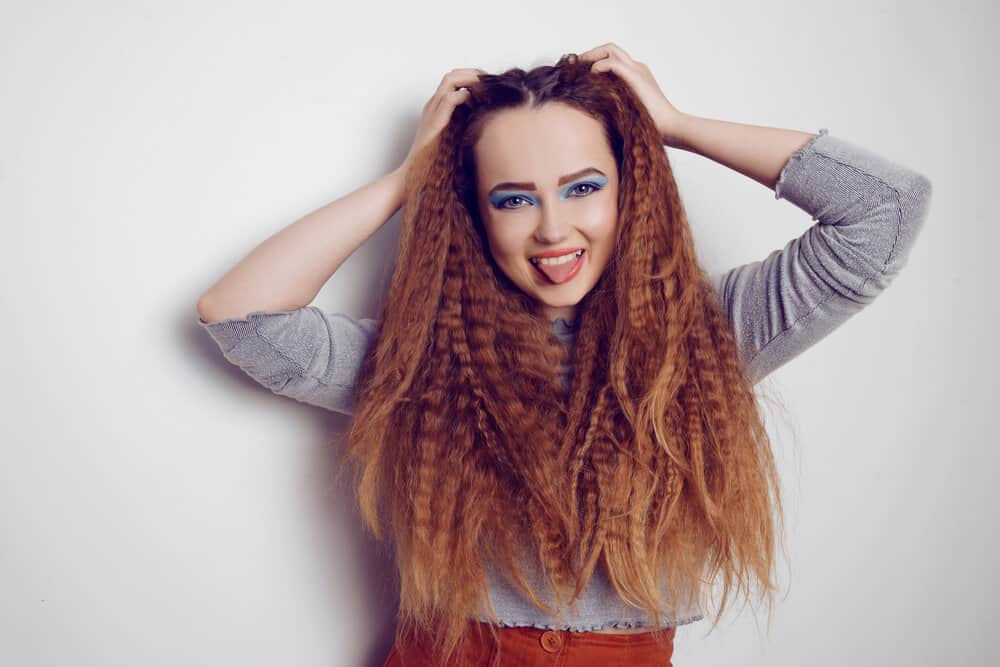 Girl with a voluminous crimped hair look created on slightly damp hair with a curling iron on type 1C straight hair.