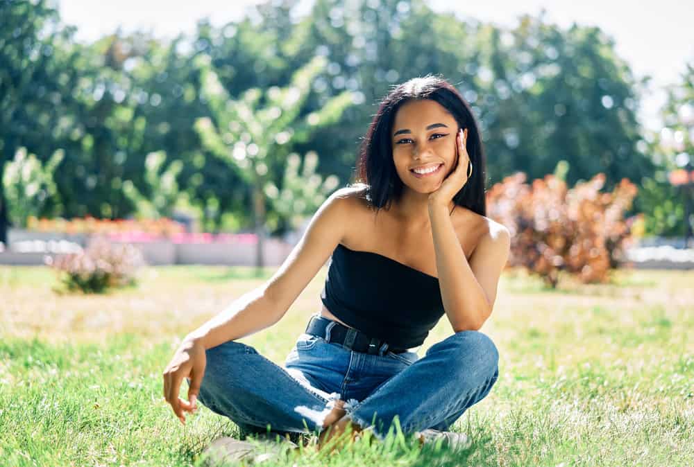 African American female with significant frizz after using heat styling tools to rough dry natural hair with direct heat.