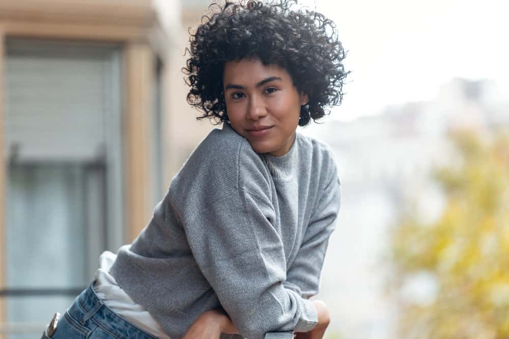 A cute female with beautiful curly hair follicles wearing her curls in a wash-n-go style created.