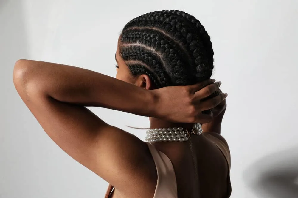 Box Braids vs. Cornrows: Which Is Better? What’s the Difference? 9 A beautiful young woman preparing for bedtime is about to wrap her hair in a silk scarf to retain moisture.