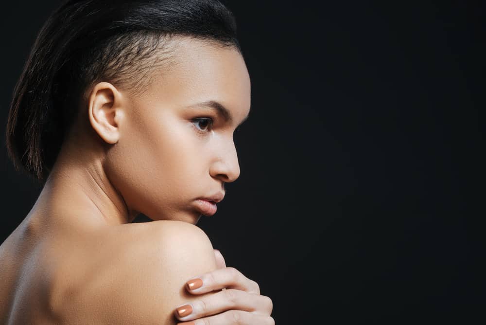 Good looking female with a glam rock mullet has a punk-edge style making the overall length appear shorter.