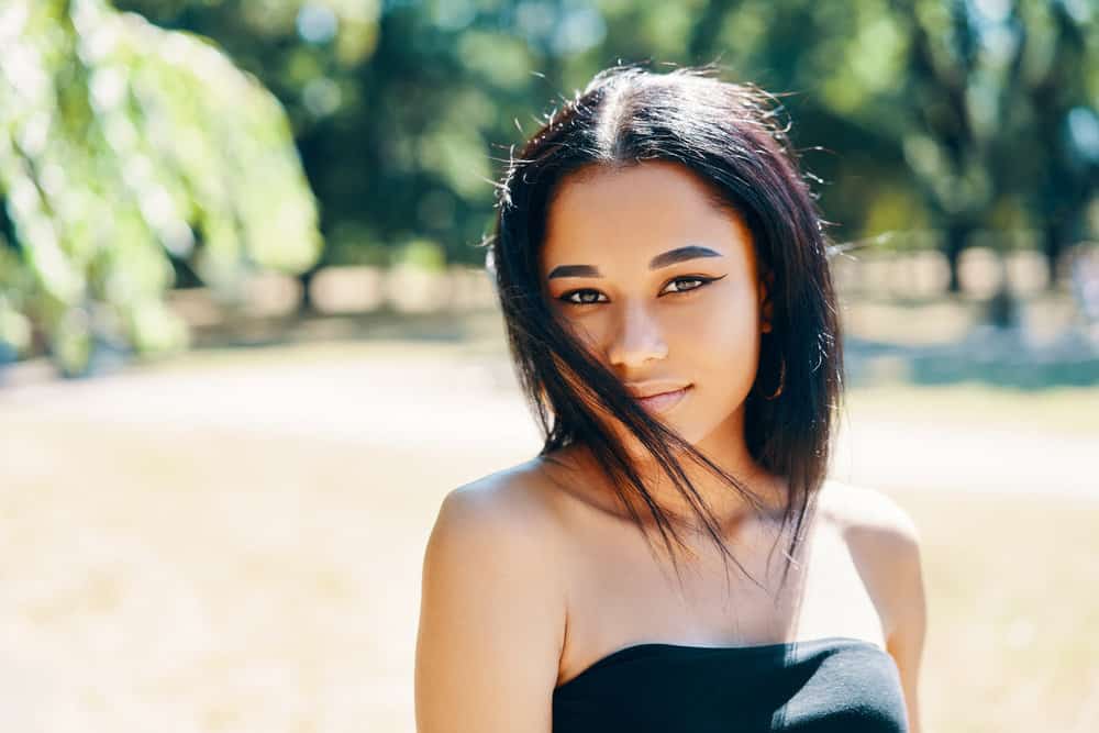 A beautiful lady with straight hair cuticles that blast hot air on her type 4 hair type to dry hair leading to damaged hair.