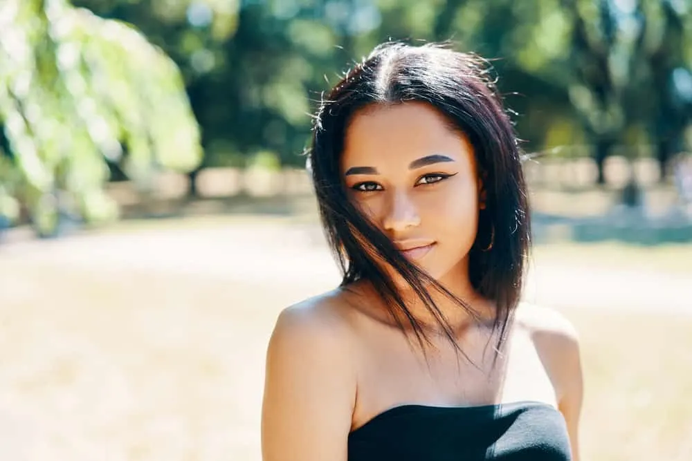 Does Blow Drying Your Hair Damage It? Should You Air Dry? 2 A beautiful lady with straight hair cuticles that blast hot air on her type 4 hair type to dry hair leading to damaged hair.