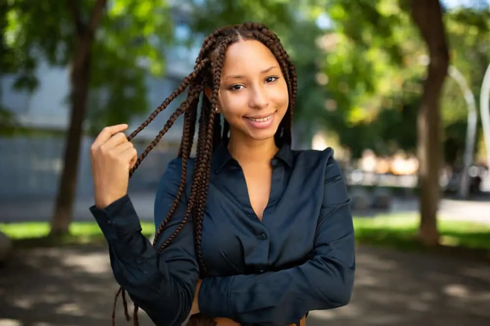 The 10 Best Summer Protective Hairstyles for Natural Hair 6 A cute African female that looks like Jada Pinkett Smith is wearing crochet braids with worn, curly ends.