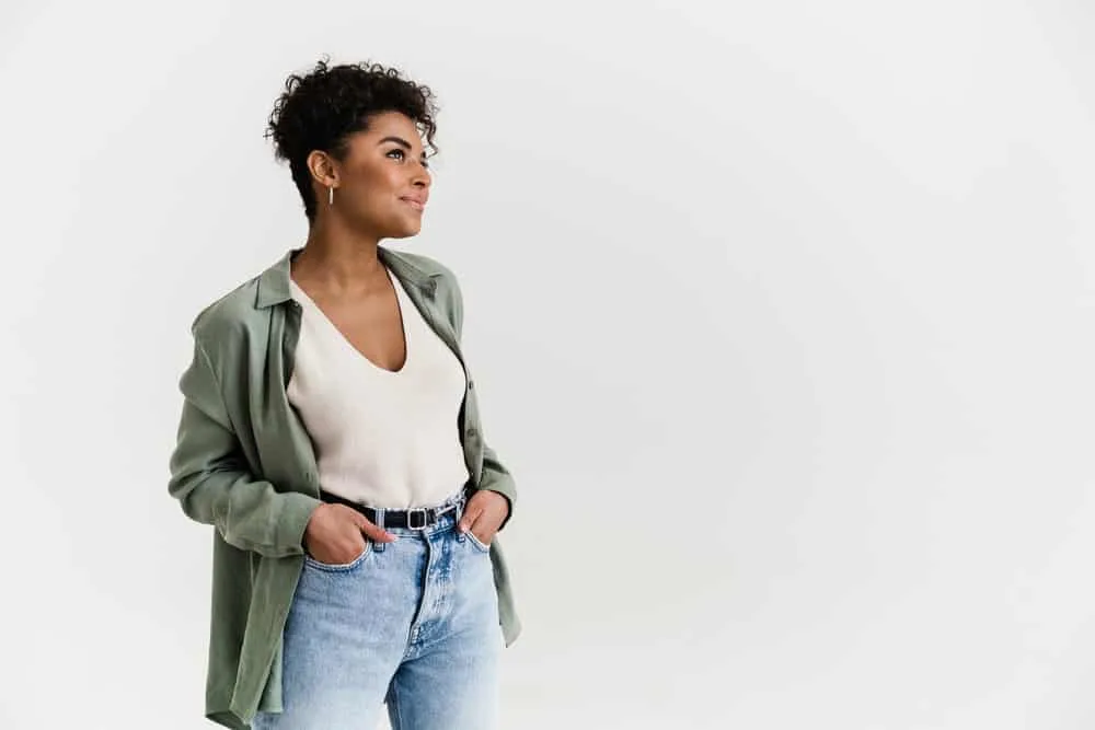 Can Micellar Water Remove Hair Dye From Skin? All Skin Types? 6 A young black woman with hair dye stains on her shirt after recently dyeing her curly hair a dark brown color.
