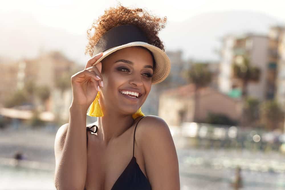 A female used coconut oil and swim caps to keep her hair dry and protected while swimming in chlorinated pool water.