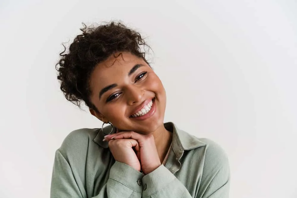 Can Micellar Water Remove Hair Dye From Skin? All Skin Types? 1 A happy young black girl used makeup remover to gently rub leftover hair dye off her skin quickly.