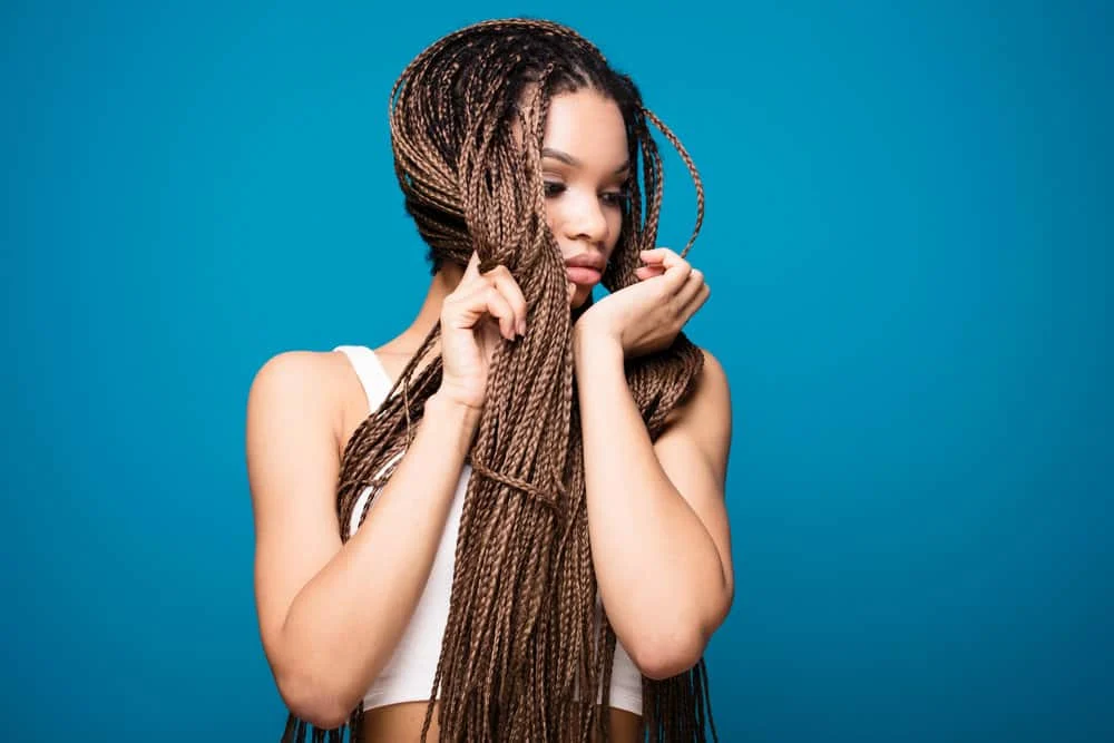 Popular Side Part Tribal Braids With Curls, Color, and More 14 A young black female is wearing Fulani braids - an adorable hairstyle for African women that want a Goddess braids-look.