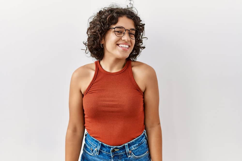 Hispanic woman with a darker complexion and naturally curly hair (i.e., textured hair) from Mexico City, Latin America.