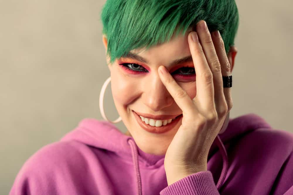 A white girl with type 1 hair cuticles and bleached hair colored with green dye faded with anti-dandruff shampoo.