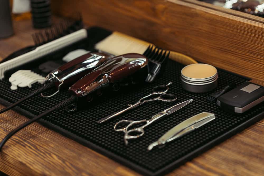 A new barber with dull clipper blades showing visible rust and a broken spring tension from cutting animal hair.