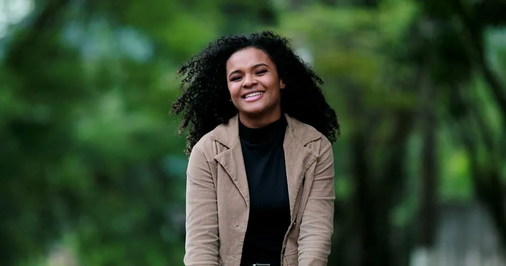 How To Use Olaplex 3 Treatment at Home for Best Results 6 A happy young black female dried her damp hair after using an Olaplex intense moisture mask for broken bonds.
