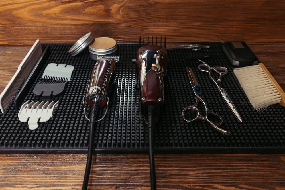 A barbershop mat is showing ceramic clipper blades that were recently purchased from the beauty supply store.